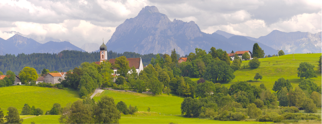Panorama Landschaft in Bayern mit Ort Seeg im Allgäu und Berg Säuling bei Füssen